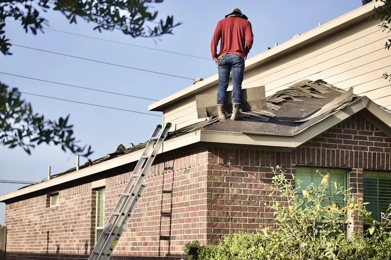 Professional roofer working on a residential roof in Saxton Falls